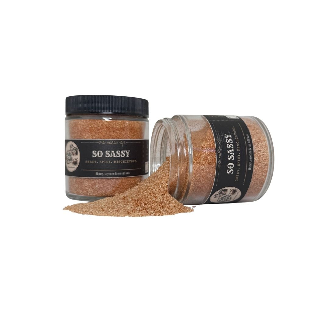 Two jars of 'So Sassy' spice blend on a white background