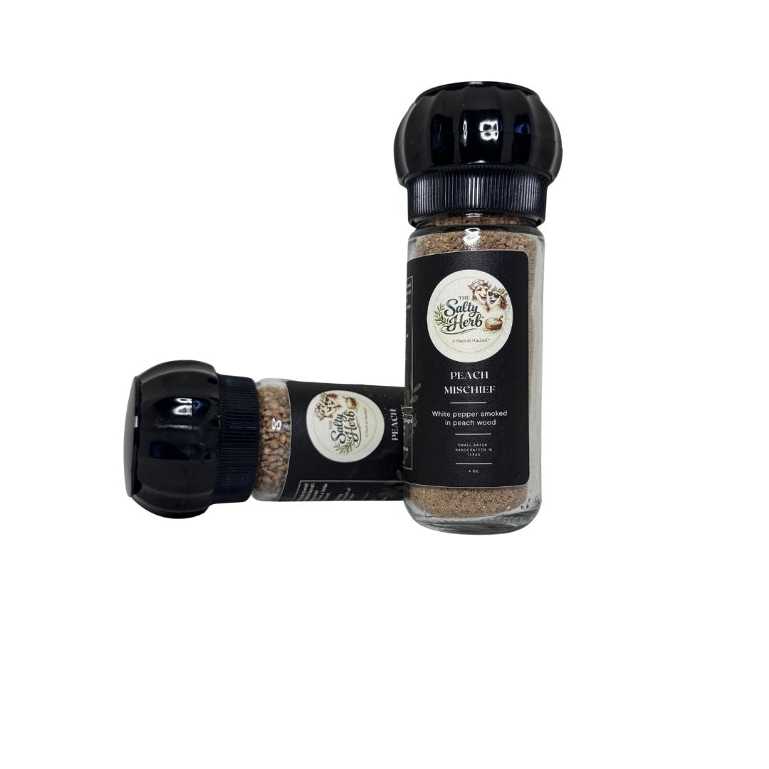 Spice shaker with black lid and visible brand label on a white background